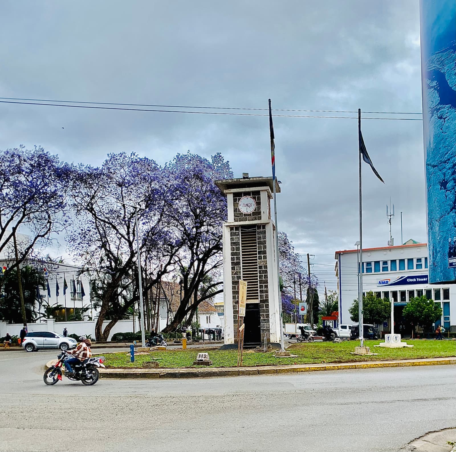 The clock tower roundabout in Arusha with jacaranda trees in bloom